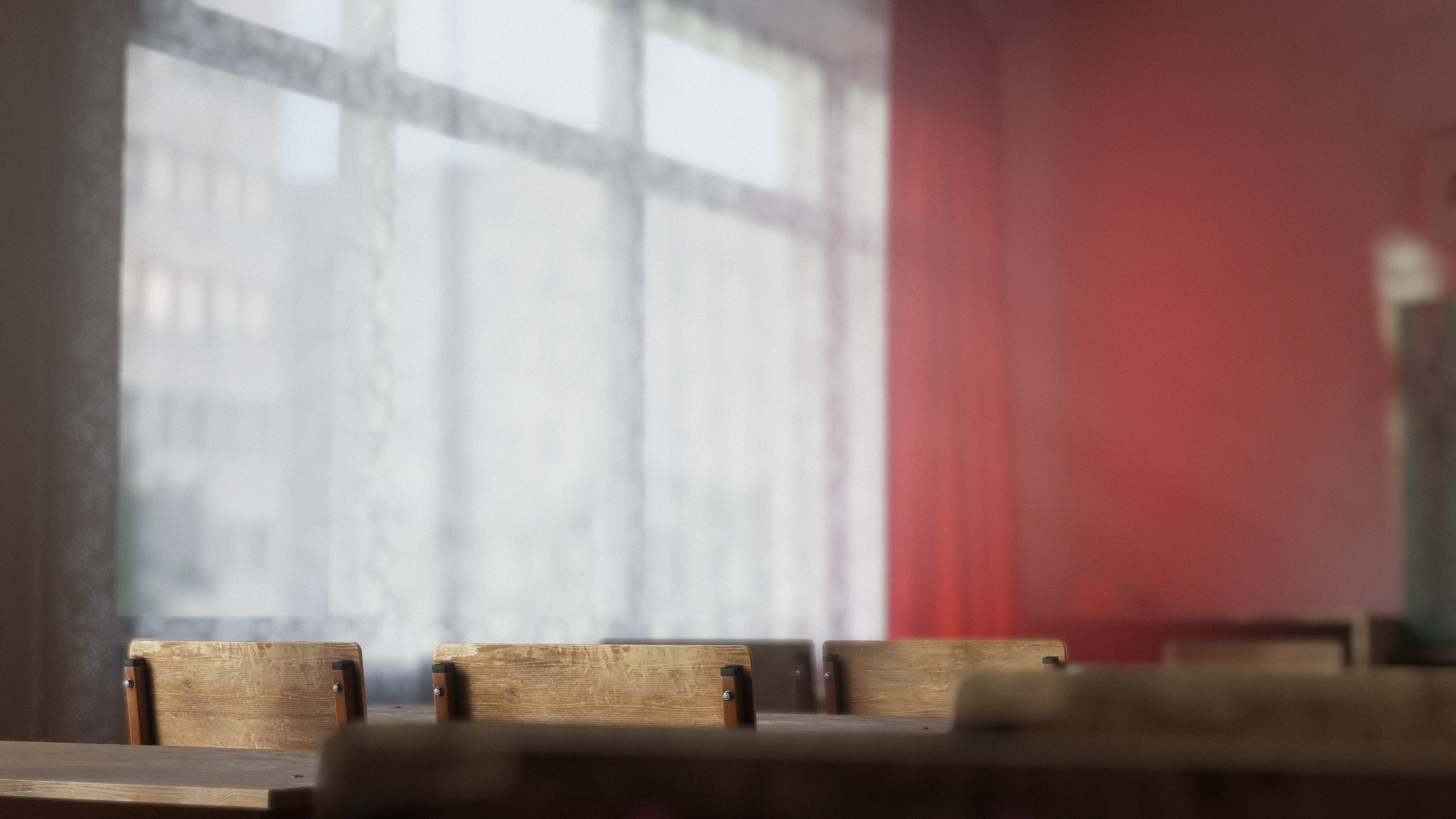 Empty classroom with wooden desks, bright windows, and a red wall in VRChat.